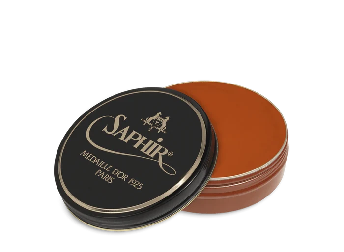 A round tin container of Saphir Medaille D'Or shoe wax polish with black lid and gold lettering.