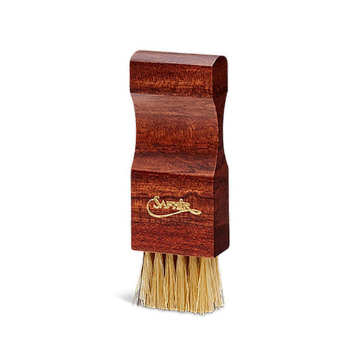 A shoe cream applicator brush with a wooden handle and boar bristles, branded with 'Saphir'.