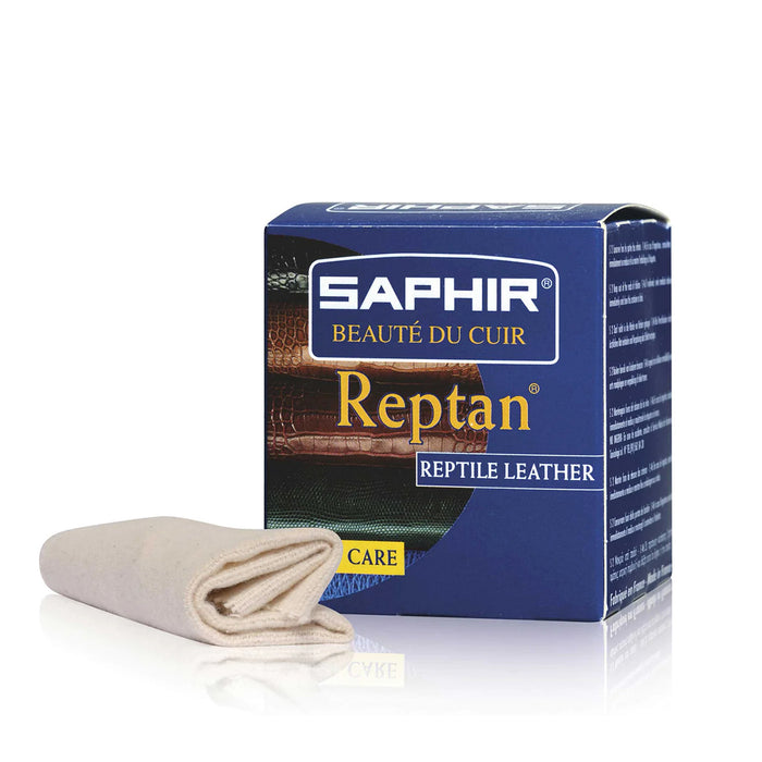 A box of Saphir REPTAN Reptile Beauty Milk with a 50ml measure indicated, alongside a chamois cleaning cloth.
