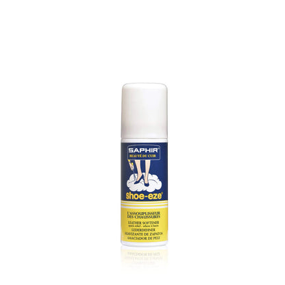 A white spray can of Saphir Shoe-Eze Leather Softener Spray with product information and branding on the label.