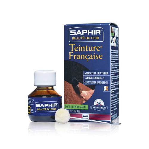 A product image featuring a box and bottle of Saphir Teinture Francaise dye for leather, with a color swatch and branding visible.