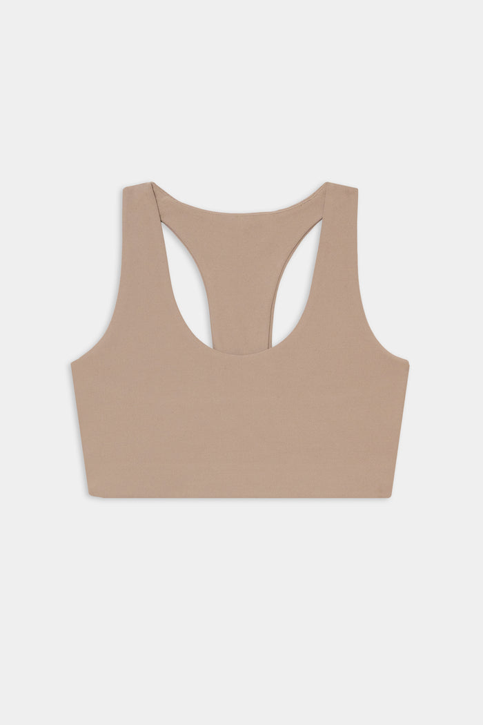 The SPLITS59 Sara Airweight Bra in Latte is shown laid flat on a white background—ideal for hot yoga or Pilates.