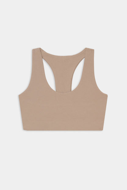 The SPLITS59 Sara Airweight Bra in Latte is shown laid flat on a white background—ideal for hot yoga or Pilates.