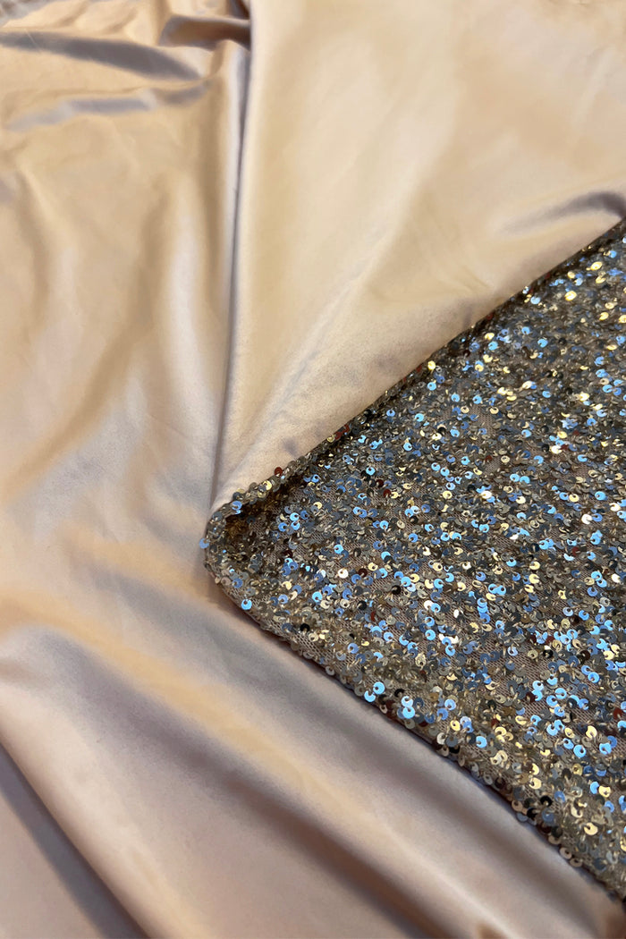 Silver sequin discs and weighted satin lining on the iconic Sequin Maxi Wrap Jaspre Skirt.