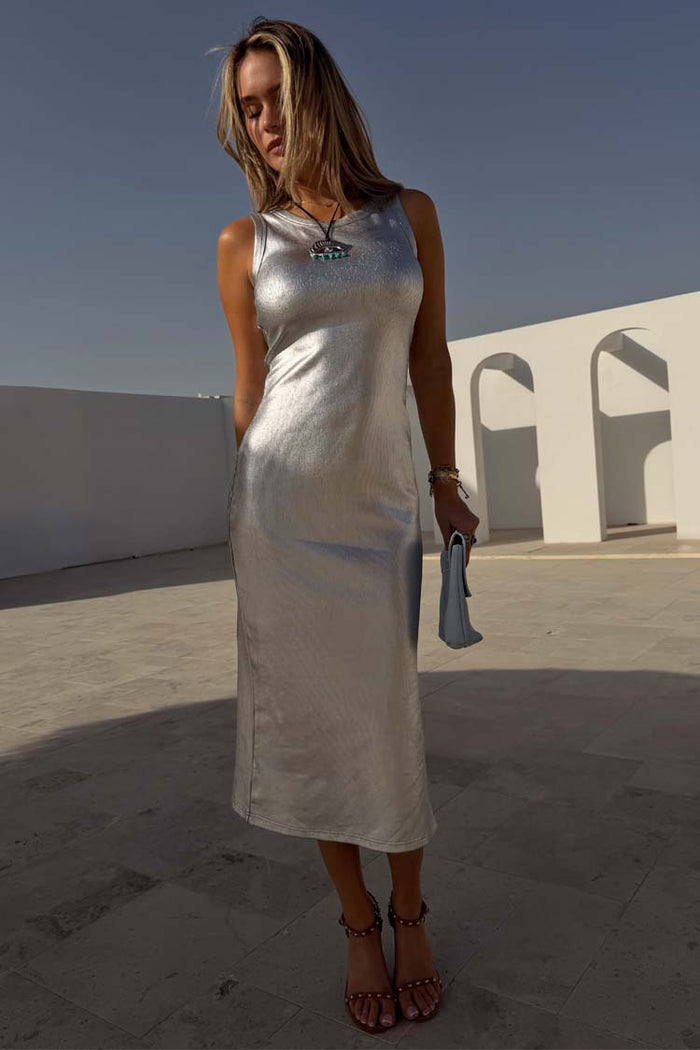 Silver Metallic Ribbed Midi Dress with a sleeveless silhouette, worn by a model in a sunlit outdoor setting.