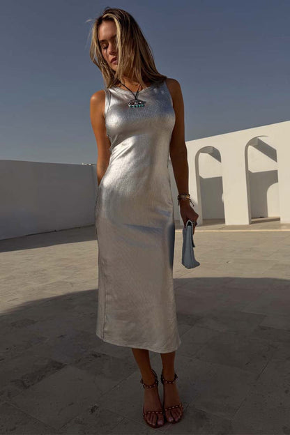 Silver Metallic Ribbed Midi Dress with a sleeveless silhouette, worn by a model in a sunlit outdoor setting.