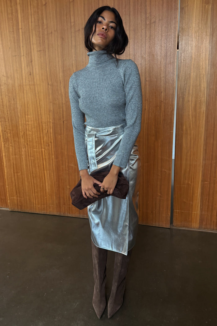 Iconic Silver Vegan Leather Jaspre Skirt styled with a grey roll neck and brown suede boots.