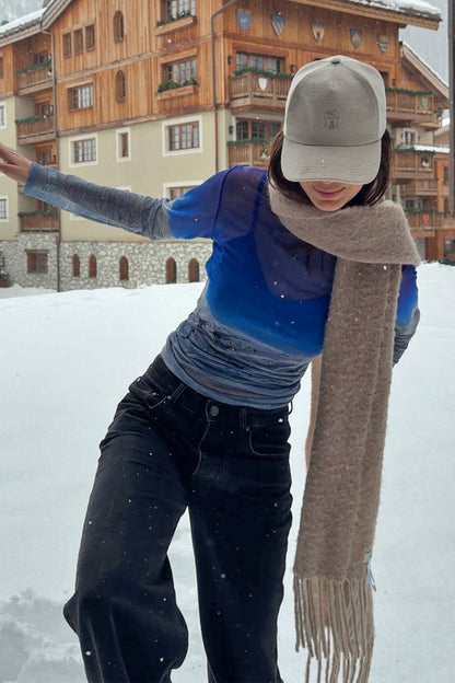 Blue gradient Ski Slopes Mesh Long Sleeve Top in sheer mesh, worn by a model outdoors in a snowy ski resort.
