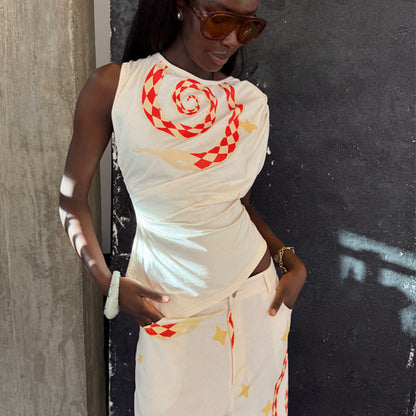 Snake Asymmetric Top in white with a red snake print, star motifs and gathered waist detailing on a model.
