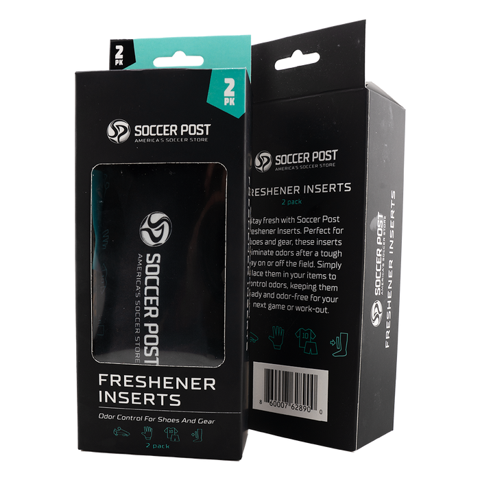 Two black boxes of Soccer Post Freshener Inserts are shown side-by-side against a white background. One box is positioned to show the front with a clear window revealing a black insert inside, while the other shows the side and back with product descriptions and a barcode. Both boxes feature teal accents, the brand logo, and icons for shoes and athletic gear.
