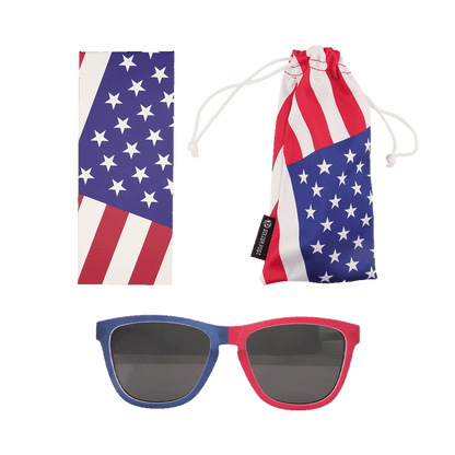 A set of American flag-themed accessories featuring patriotic red, white, and blue colors. The set includes a pair of sunglasses with one blue frame and one red frame, a rectangular cleaning cloth with a star and stripe pattern, and a matching soft drawstring pouch labeled with a "Soccer Post" tag.