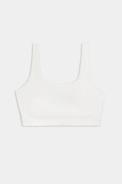The SPLITS59 Sprint Rigor Bra - White is a sleeveless sports bra with a scoop neckline, perfect for gym workouts and multi-sport performance, showcased on a plain light background.