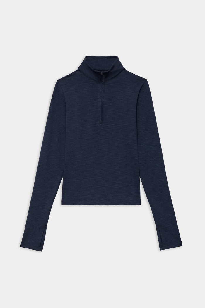 The SPLITS59 Stevie Active Rib Half Zip Waist Length in Heather Indigo, a long-sleeve pullover with thumb holes, is shown laid flat on a white background.