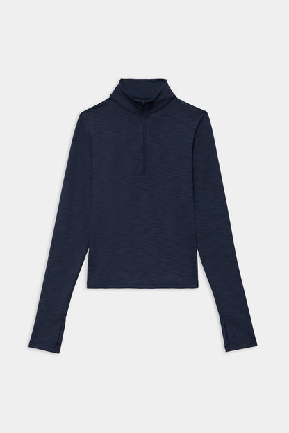 The SPLITS59 Stevie Active Rib Half Zip Waist Length in Heather Indigo, a long-sleeve pullover with thumb holes, is shown laid flat on a white background.