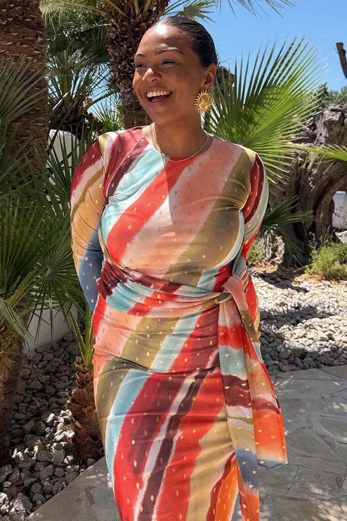 Sunset Stripe Mesh Midi Dress with a multicoloured stripe print and wrap tie waist on a curve model.