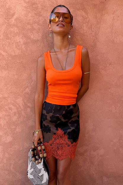 Maeva mini skirt in tan Jaden floral print with a burnt orange lace hem and ribbed orange vest.