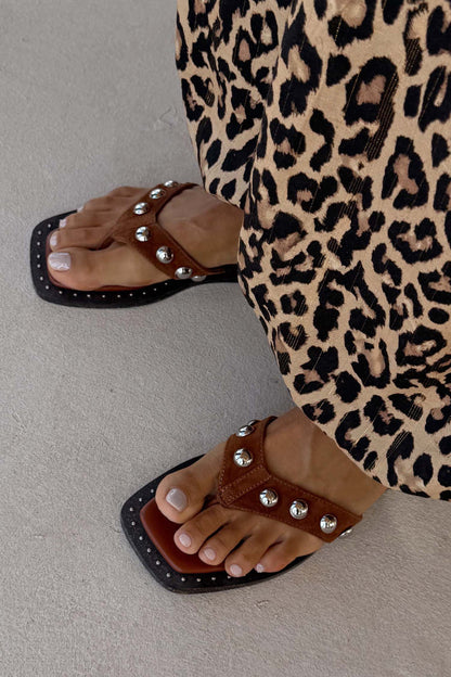 Tan Leather Stud Sandals with silver studs and a square toe, styled with a leopard print skirt.