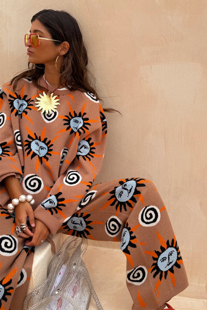 Tan Sun Copenhagen Jumper and matching knit trousers with hand-painted sun and swirl motifs.
