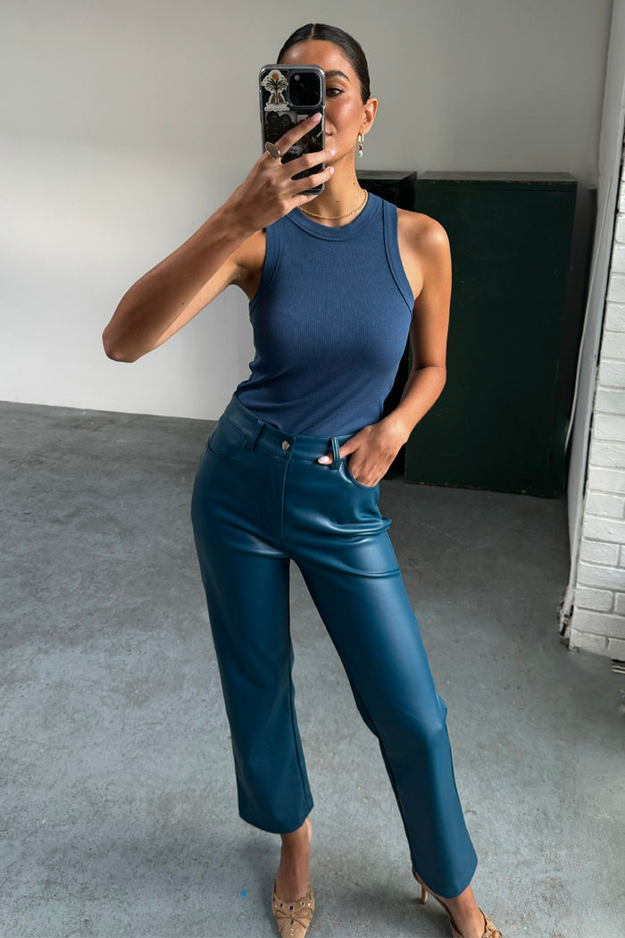 Teal Vegan Leather Trousers in a straight leg cut, styled with a blue rib tank top in a mirror selfie.