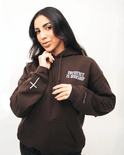 Person wearing a brown hoodie with text on a white background