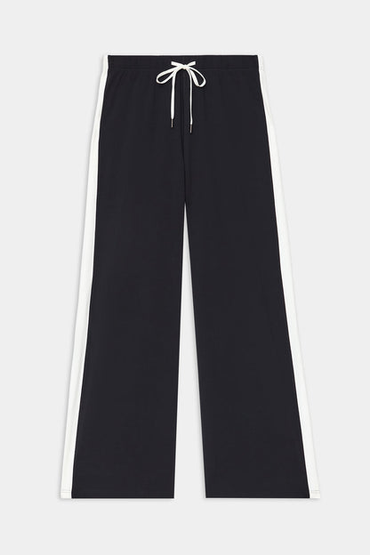 The SPLITS59 Willow Airweight Wide Leg - Black/White features white side stripes and a white drawstring at the elastic waist, crafted from buttery-soft fabric and shown on a plain background.