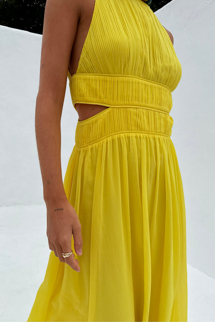 Yellow Ella Dress featuring pleat detailing, side cut outs and a defined pleated waistband.