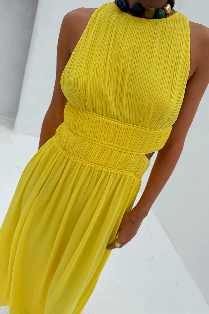 Yellow Ella Dress featuring a pleated texture, high neck and side cutouts on a 5ft5” model in a UK size 8.