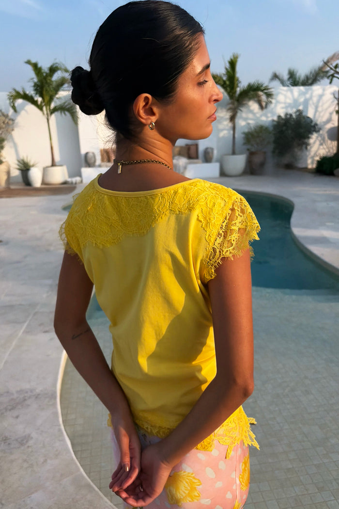Yellow Lace Insert Top with lace detailing at the back and sleeves, captured in a poolside vacation setting.