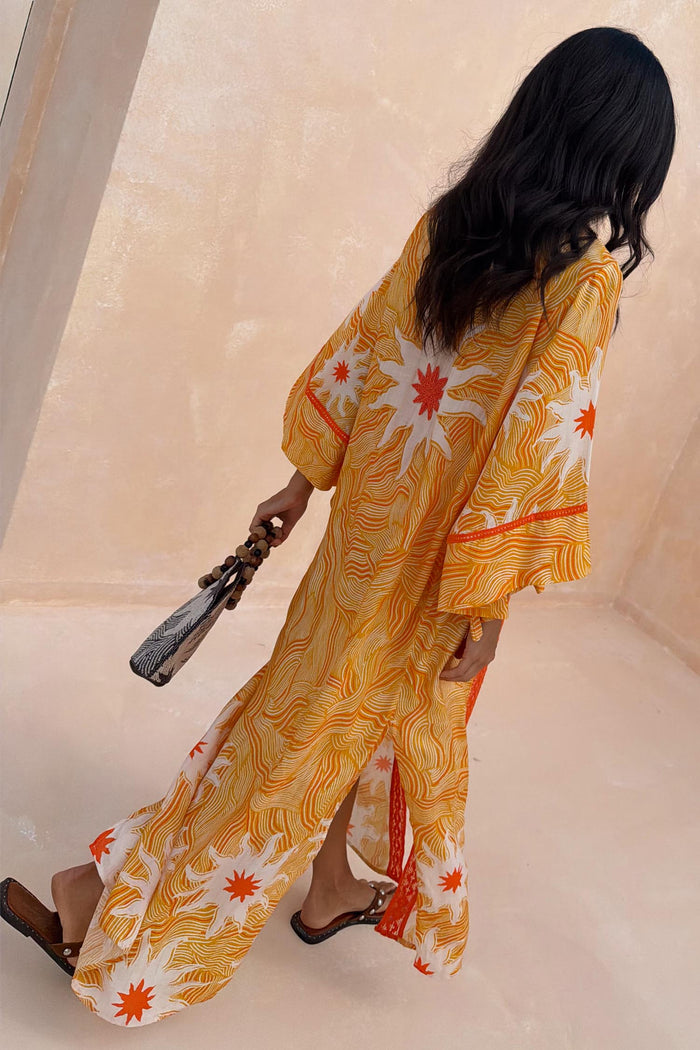 Yellow Sun Kimono in Soleil print featuring wide sleeves, side splits and beaded back detailing.